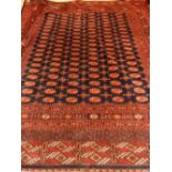 An Indigo ground Bokhara carpet, decorated with six rows of elaphant pad medallion to centre,