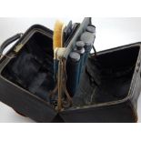 A late 19th century dressing case, black leather Gladstone type,