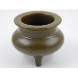 A Chinese tea dust glazed incense burner, raised on three feet, H.