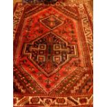 A red ground Caucasian rug,