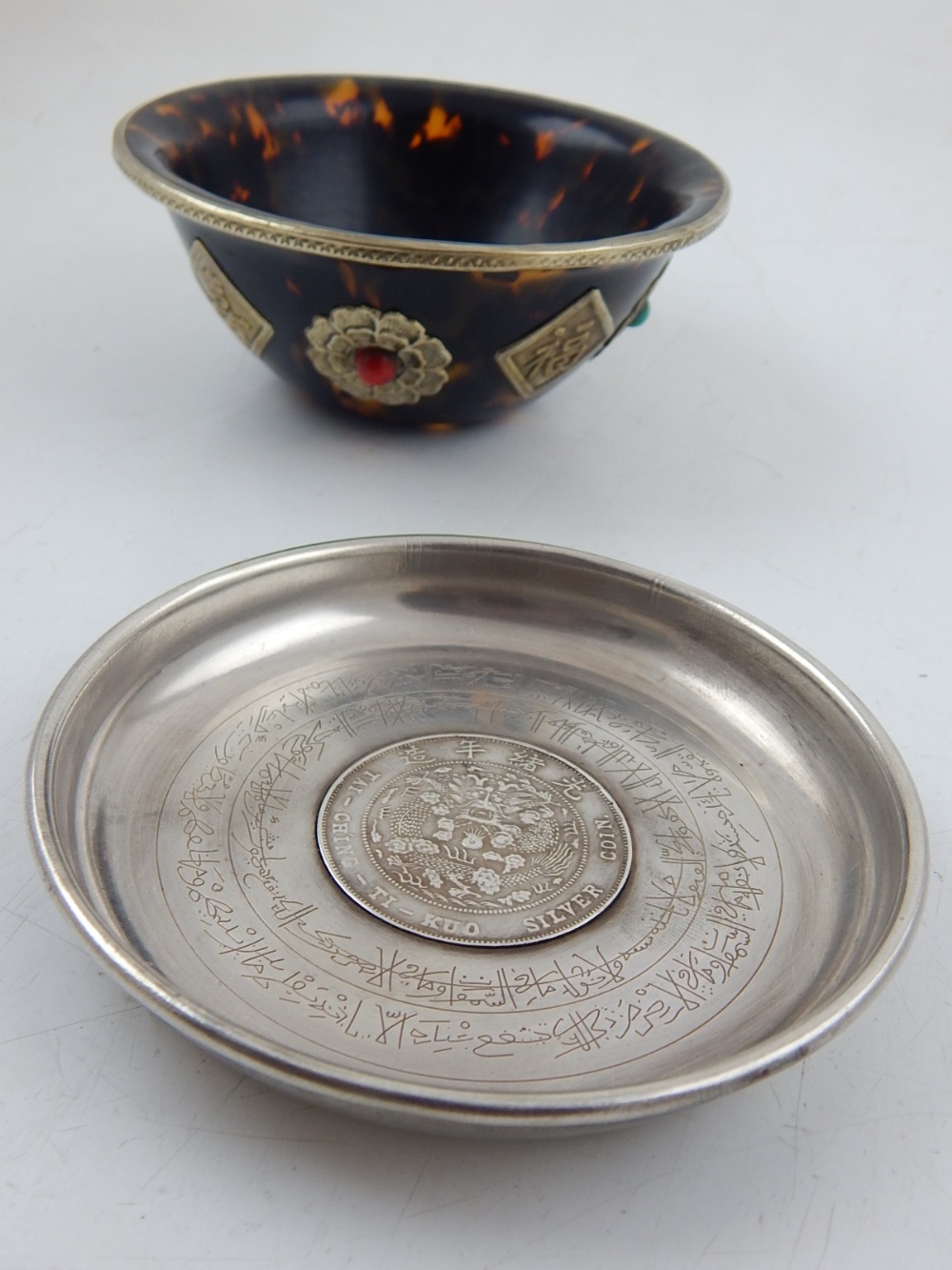 A faux tortoiseshell and white metal decorated bowl,
