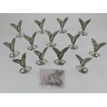 A set of fourteen Spanish white metal card placement holders,
