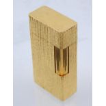 A Waterman's gold plated cigarette lighter of rectangular form.