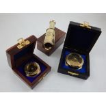 A brass three draw telescope within a wooden box, together with a compass and a 111 year calendar,