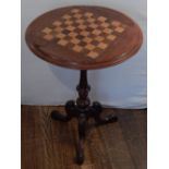 A Victorian mahogany chess table, the circular top incorporating a chess board,