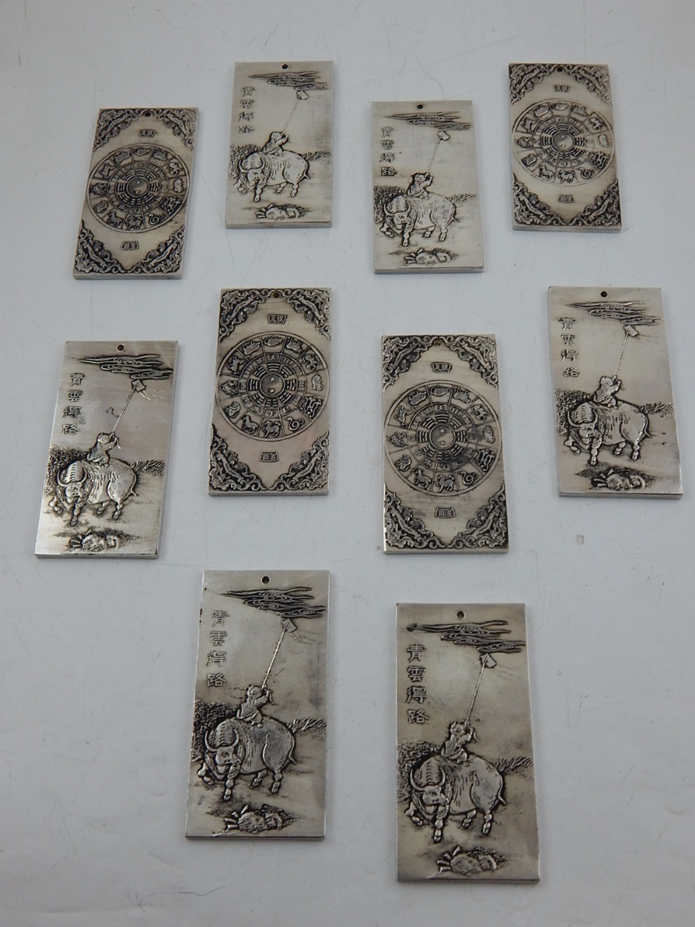 Ten Chinese white metal tokens,