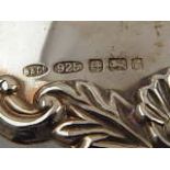 A pair of silver decanter labels for port and brandy, having scalloped shell and vine decoration,