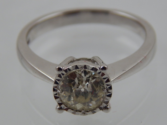 An 18 carat white gold and solitaire diamond ring, set old cut stone of approx. 1.0 carats.