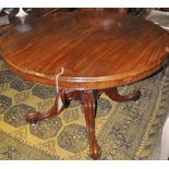 A Victorian mahogany circular tilt top breakfast table on fluted baluster column and quadruple