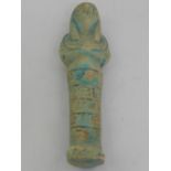 An Egyptian clay and partially turquoise glazed shabti figure, decorated with hieroglyphs.