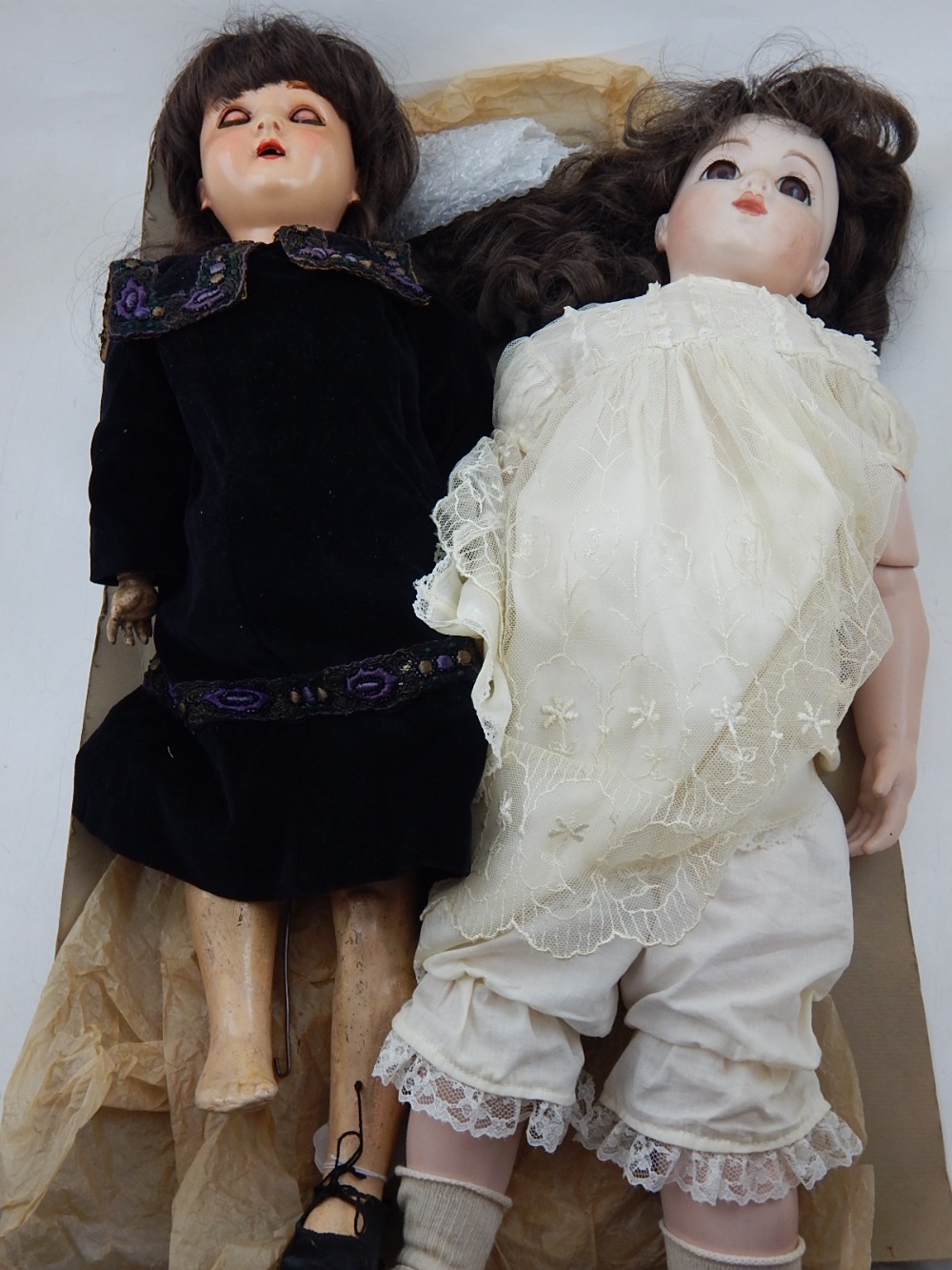 An early 20th century Schoenau and Hoffmeister celluloid doll with sleeping eyes,