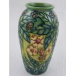 A Moorcroft vase, tube lined decorated with flowers and foliage, bears WM Moorcroft 51/100 to base.