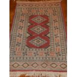 A Caucasian rug, decorated with stepped medallions to centre, within reticulated borders, fringed,