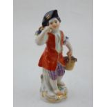 An early 20th century Meissen porcelain figure of a grape picker wearing a tricorn and red