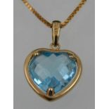 A 9 carat yellow gold and faceted blue topaz heart-shaped pendant,