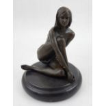 A contemporary cold cast bronze nude study, seated cross legged, raised on a circular base, H. 17cm.