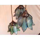 A three branch Tiffany style ceiling light, having coloured leaded glass shades,