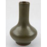 A small Chinese tea-dust glazed vase, the compressed globular body tapering to the cylindrical neck,