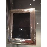 A white metal rectangular photograph frame, having spot hammered decoration, stamped 925. H: 19cm W: