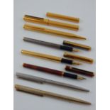 A collection of seven Dunhill fountain pens and ball point pens, some having yellow metal nibs