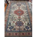 A cream ground Heriz carpet, decorated with hexagonal medallion to centre on a geometric ground,