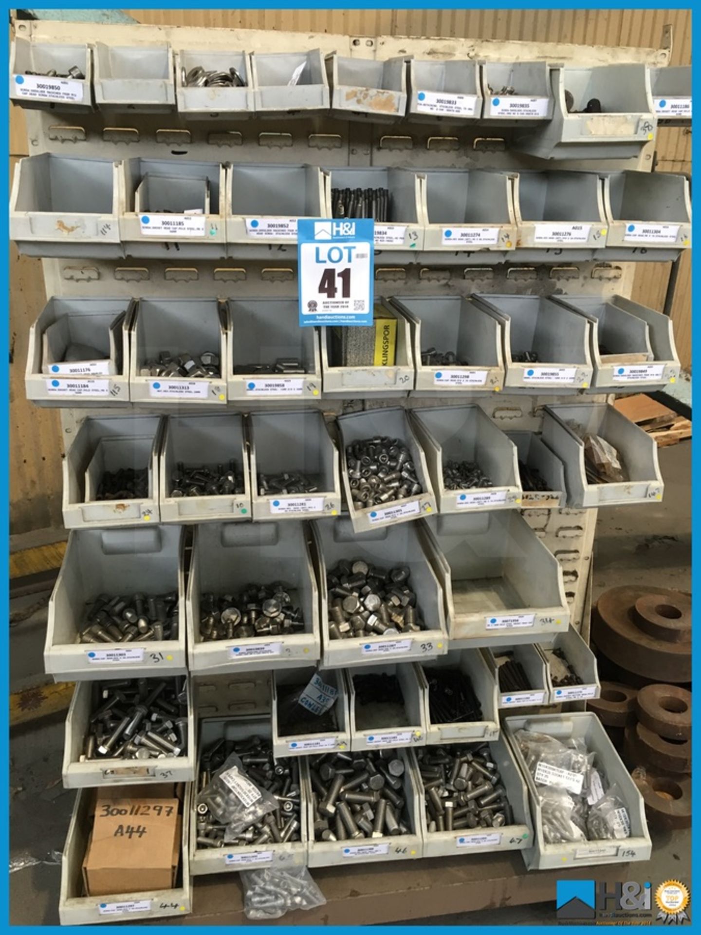 Excellent lot of assorted lin bins with rack on castors. Lin bins contain mainly unused nuts,