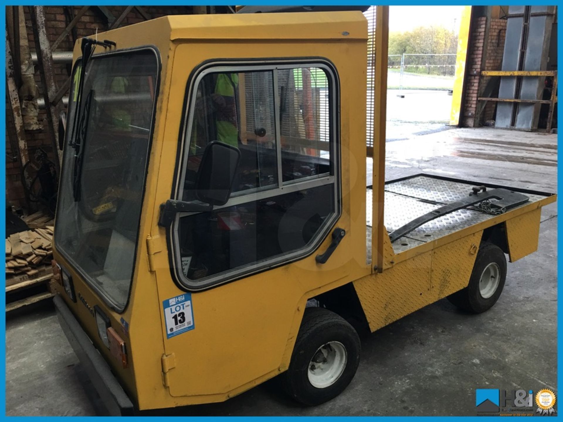 Electricars electric tug truck. Appears in good working order. Comes with charger. Showing 920 hours