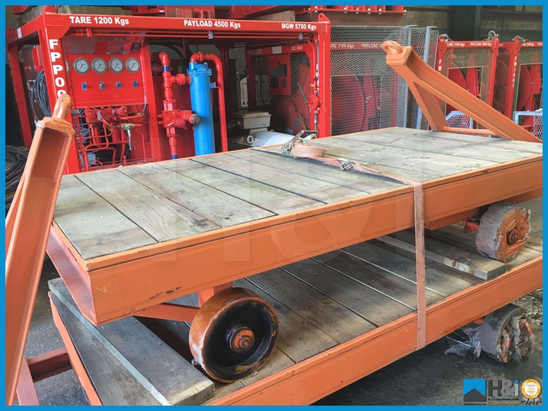 Unused wheeled trolley bogey with steerable axle and urethane wheels. Timber decked, 10 tonne