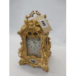A reproduction carriage clock with pink enamel decorated porcelain face and sides decorated birds,
