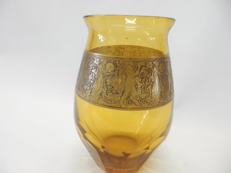 A Moser amber vase decorated in a band with gilded figures of Bacchanalian figures, signed to the