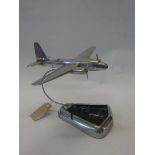 A chrome model of an American bomber plane bombing a submarine, on shaped base - 9in. high