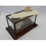 A barograph in an oak and glass case, complete with papers