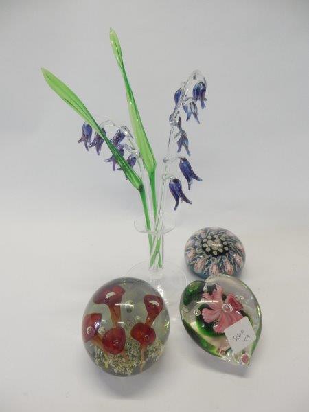 A collection of paperweights, some with floral canes, intaglio paperweight decorated duck, a small