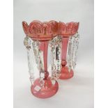 A pair of Victorian cranberry lustres with gold painted decoration, icicle form drops - 11 1/4in.