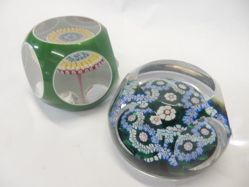 A Baccarat faceted paperweight, green with floral canes and a faceted paperweight, green with blue
