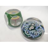 A Baccarat faceted paperweight, green with floral canes and a faceted paperweight, green with blue