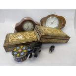 An Edwardian mantel clock with white enamel dial, in a mahogany and inlaid shaped case, a