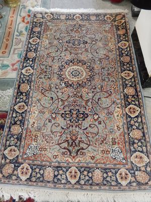 An Ispaal rug, pale blue field with repeating floral pattern centre and border, fringed