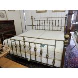 A kingsize bed with matching brass bedstead
