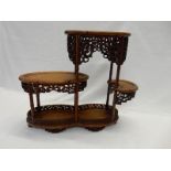 Two Chinese hardwood three tier stands of oval form