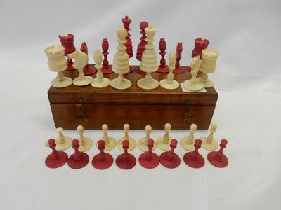 A turned and stained ivory chess set, in a walnut box