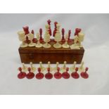 A turned and stained ivory chess set, in a walnut box