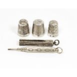 Three silver thimbles, a silver cased propelling pencil and one other