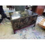 A modern Chinese black lacquered box decorated flowering branches, on shaped short legs