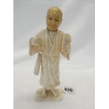 A Japanese sectional ivory figure of a mask seller