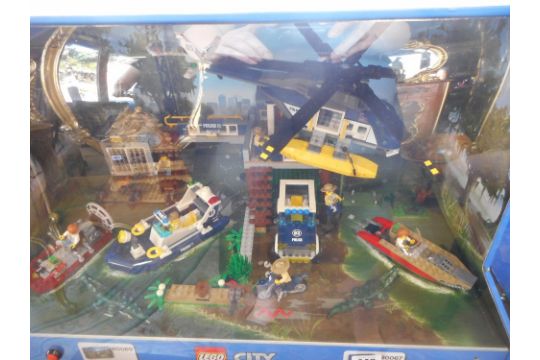 A Lego City ex shop display nos. 60069 and 60067 in a lighted case - Swamp  Police Station and Hel