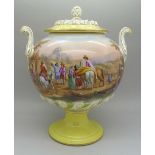 A Helena Wolfsohn vase and cover, with a yellow foot decorated with courtly visitors to a ruin,