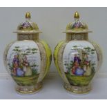A pair of Dresden vases and covers of baluster form decorated with panels of figures and flowers,