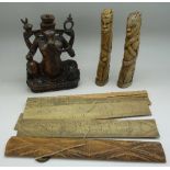 A small hardwood carving of Ganesh, two carvings of African tribesman and a Far Eastern carving,