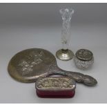 A silver backed hand mirror, a silver topped jar and a silver topped box,